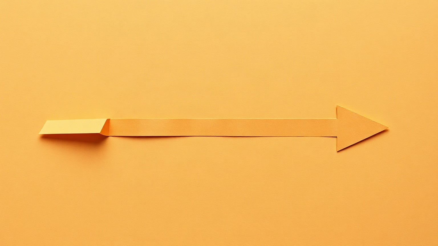 A tobacco-brown paper arrow on a warm sand ground, its tip cut off and set further along, leaving a clear gap in the middle